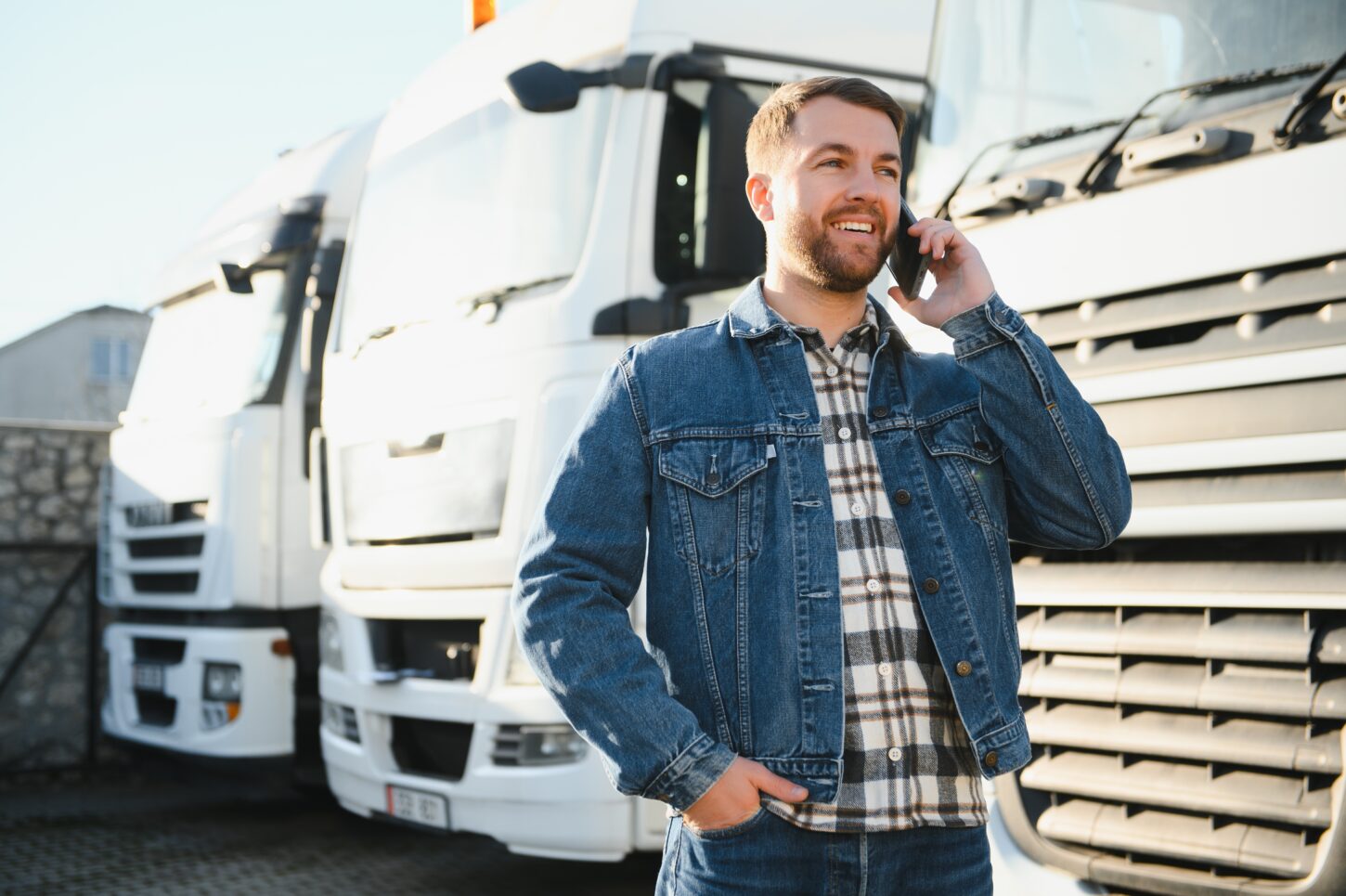 portraitofyoungbeardedtruckerstandingbyhistruckvehicle